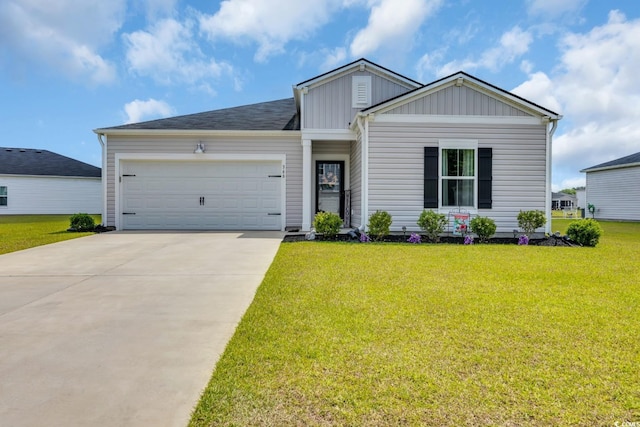 view of front of house featuring a garage, a front lawn, board and batten siding, and driveway