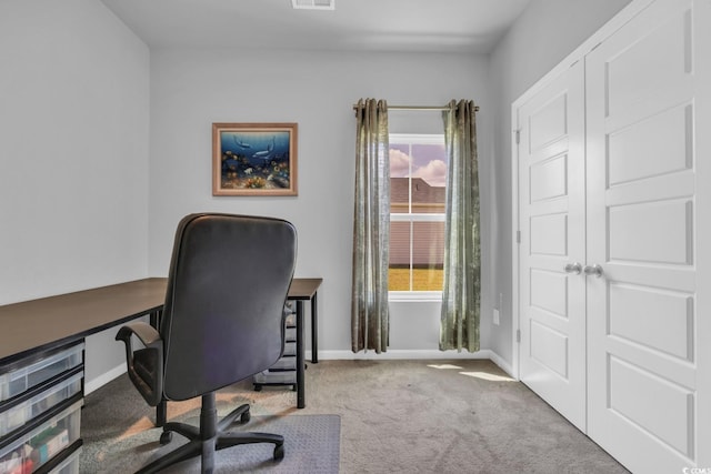 office space with baseboards, carpet flooring, and visible vents