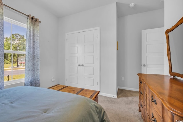 bedroom with baseboards, multiple windows, and carpet
