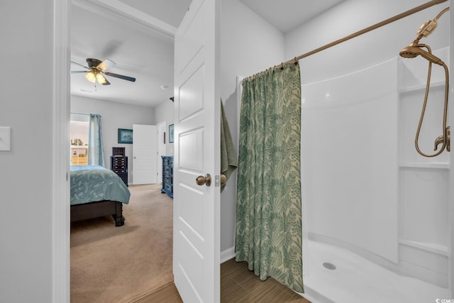 full bath featuring a ceiling fan, a shower stall, and ensuite bath