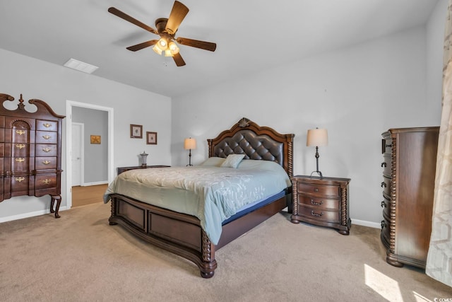 bedroom with visible vents, a ceiling fan, baseboards, and light carpet