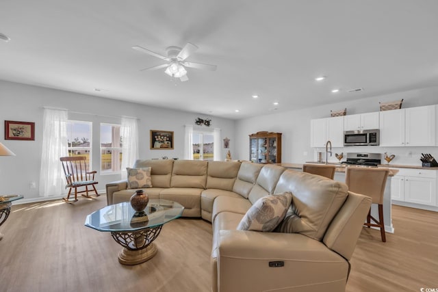 living area featuring recessed lighting, ceiling fan, light wood-type flooring, and visible vents