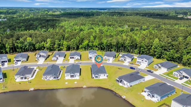 drone / aerial view with a water view, a view of trees, and a residential view