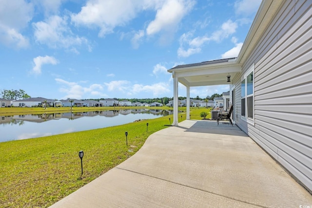 view of patio / terrace with a water view and a residential view