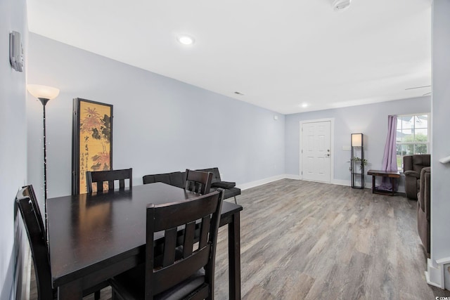 dining room with baseboards, recessed lighting, and wood finished floors