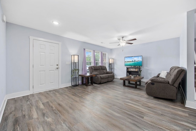 living room featuring baseboards, a ceiling fan, wood finished floors, and recessed lighting