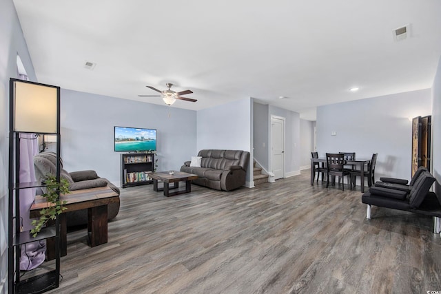 living room featuring a ceiling fan, wood finished floors, and visible vents
