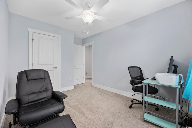 carpeted home office featuring baseboards and a ceiling fan