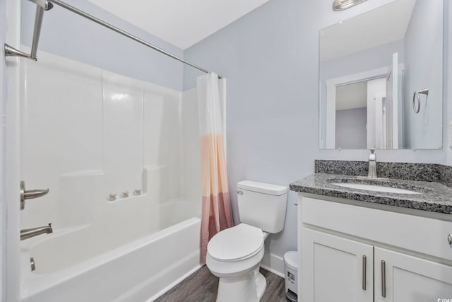 bathroom with wood finished floors, shower / tub combo, vanity, baseboards, and toilet