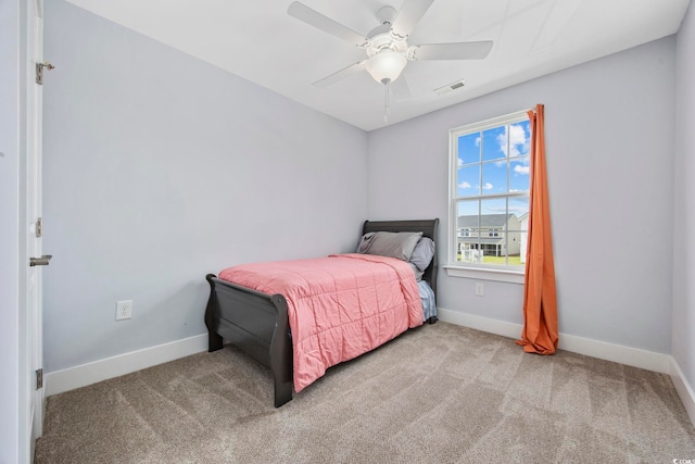 carpeted bedroom with baseboards, a ceiling fan, and visible vents