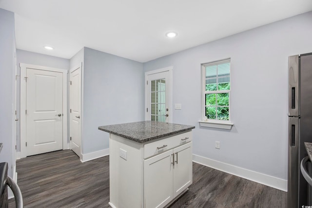 kitchen with baseboards, freestanding refrigerator, white cabinetry, and dark wood-style floors