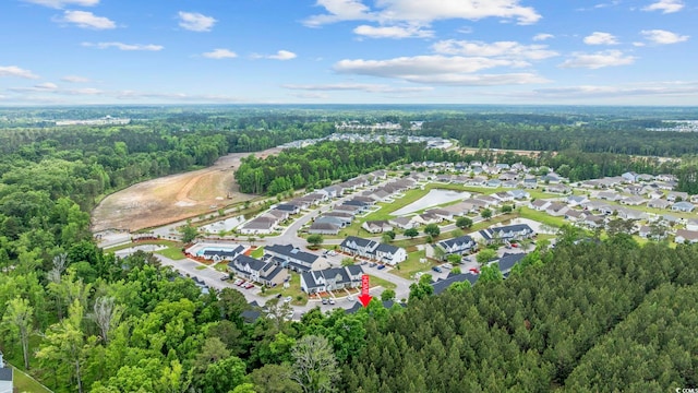 bird's eye view featuring a residential view and a wooded view