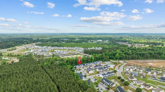 drone / aerial view featuring a residential view and a forest view