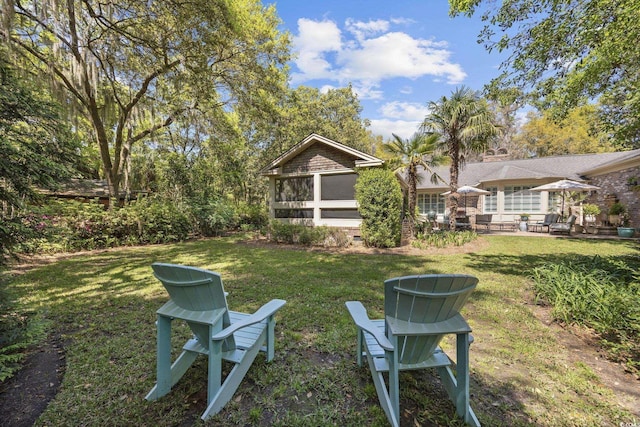 741 Tuckers Rd, Pawleys Island, SC 29585 - view of green lawn featuring a sunroom