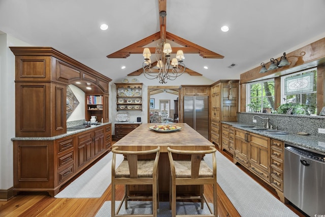 741 Tuckers Rd, Pawleys Island, SC 29585 - kitchen with stainless steel appliances, a chandelier, light wood-style flooring, light stone counters, and open shelves