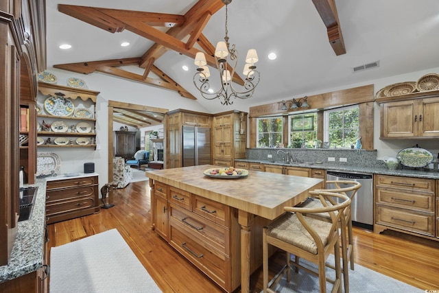 741 Tuckers Rd, Pawleys Island, SC 29585 - kitchen featuring appliances with stainless steel finishes, butcher block countertops, a chandelier, light wood-style floors, and pendant lighting