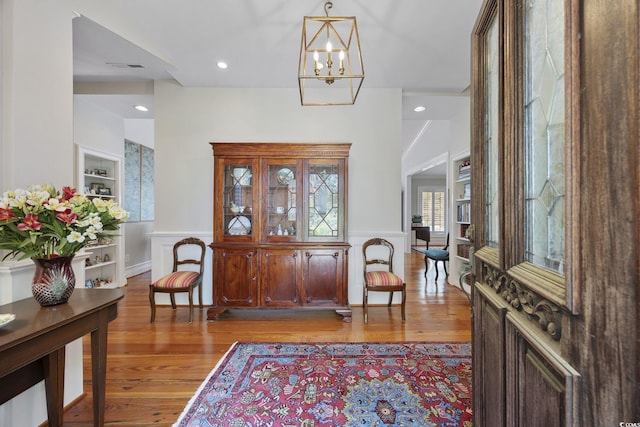 741 Tuckers Rd, Pawleys Island, SC 29585 - foyer featuring light wood-type flooring, wainscoting, and a chandelier