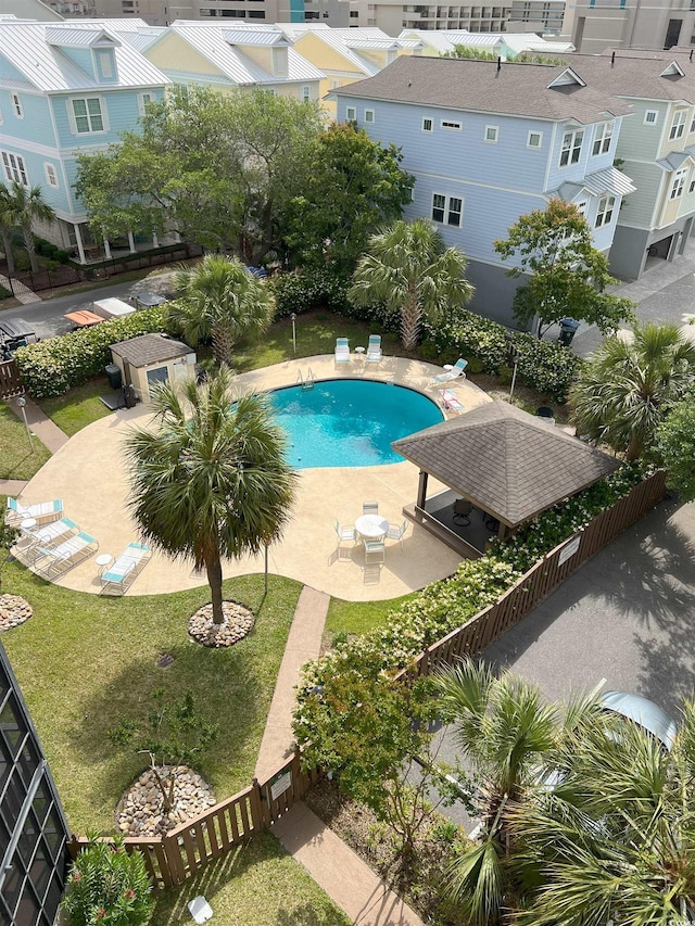 community pool featuring a patio and fence