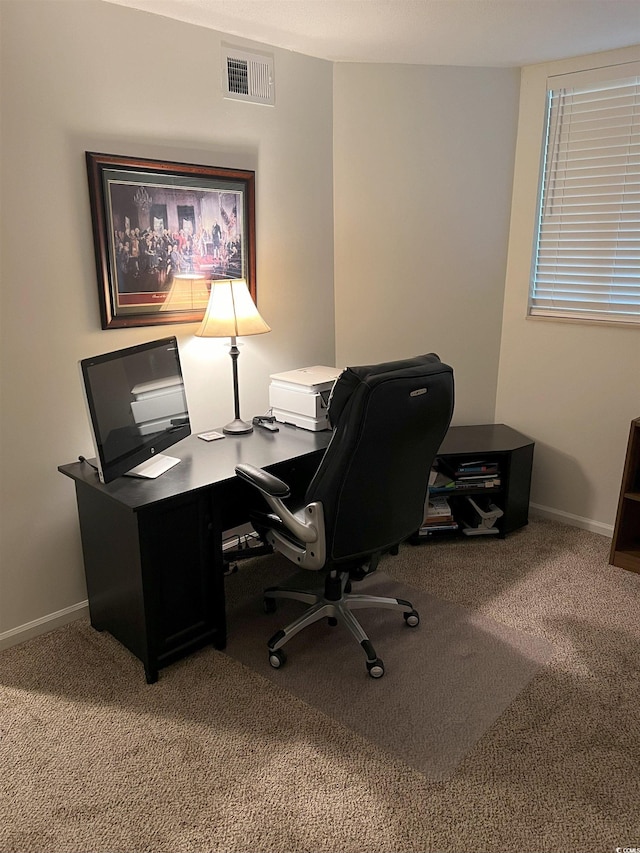 carpeted office space featuring baseboards