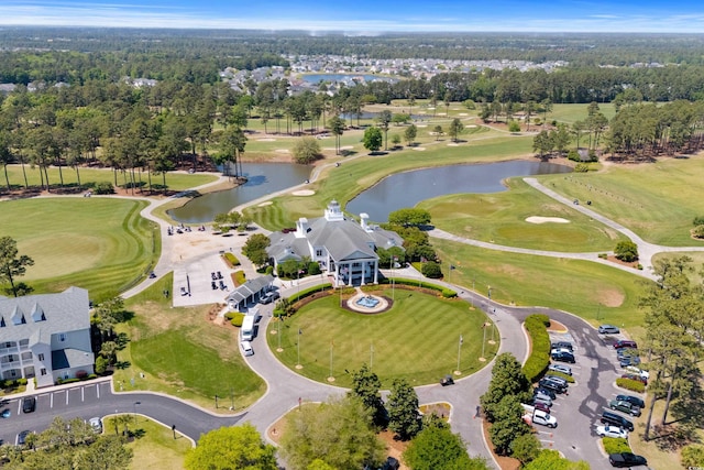 drone / aerial view with a water view and golf course view