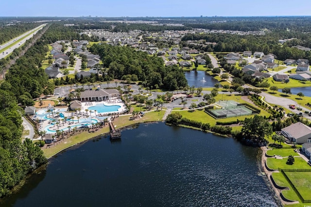 birds eye view of property with a water view and a residential view