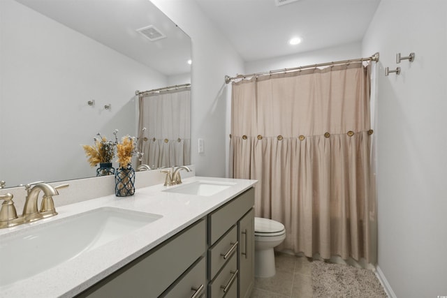 bathroom with a sink, tile patterned floors, toilet, and visible vents