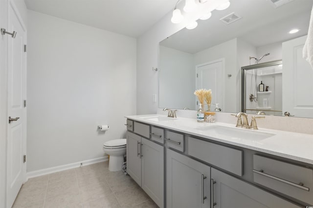 bathroom with baseboards, a sink, a stall shower, and toilet