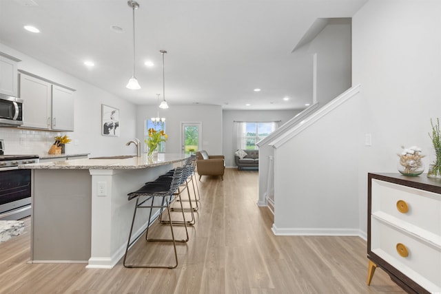 kitchen featuring stainless steel appliances, recessed lighting, and light wood-style flooring