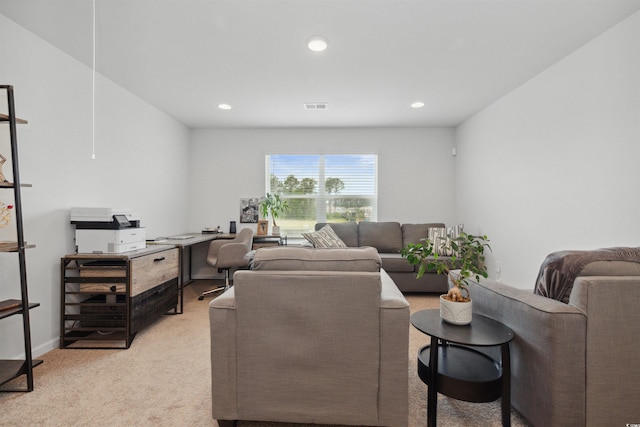 living area with visible vents, recessed lighting, and light colored carpet