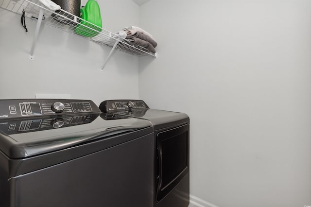 laundry area featuring washer and dryer, laundry area, and baseboards