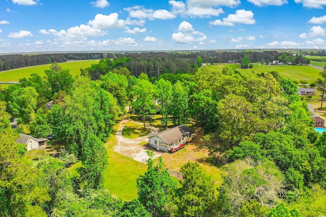 birds eye view of property featuring a wooded view