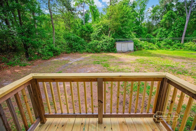 deck featuring a storage unit and an outbuilding