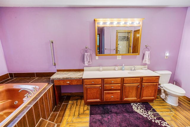 full bath with wood finished floors, vanity, toilet, and a whirlpool tub