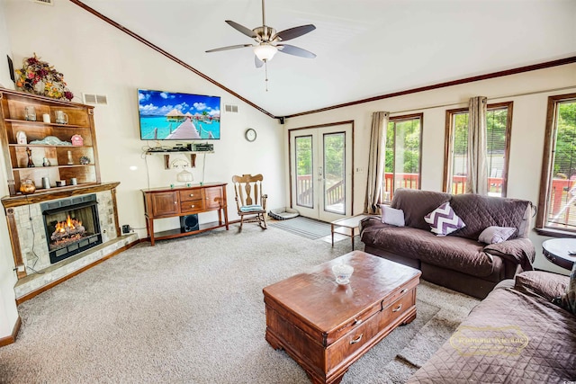 living area with visible vents, a wealth of natural light, carpet, and ceiling fan