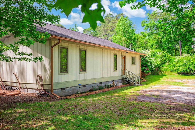 view of property exterior featuring a yard, crawl space, a shingled roof, and entry steps