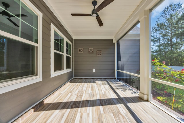 unfurnished sunroom with a ceiling fan