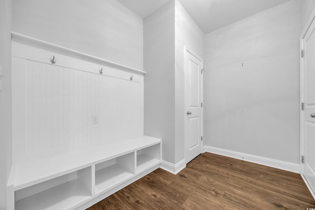 mudroom with baseboards and dark wood-type flooring
