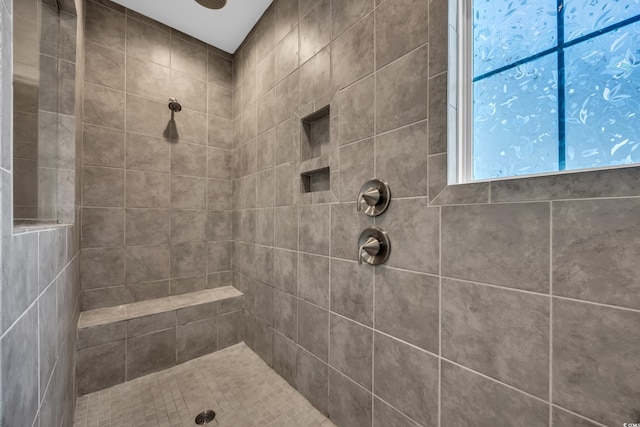 bathroom with tiled shower