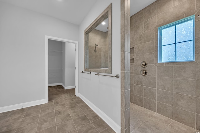 full bath with baseboards, a walk in shower, and tile patterned floors