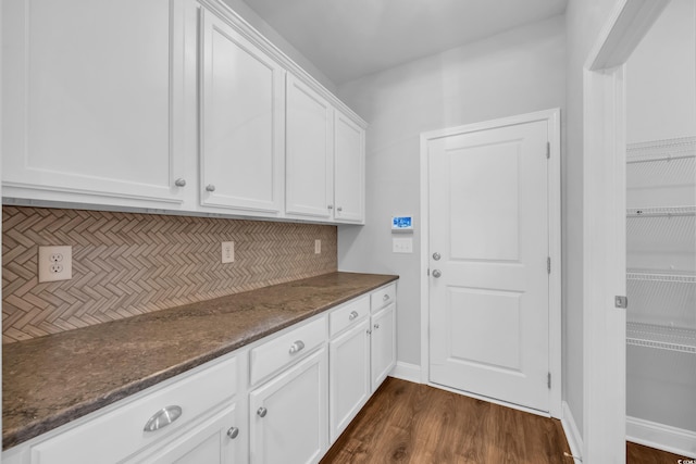 laundry room featuring dark wood-style flooring