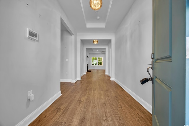 hall featuring baseboards and wood finished floors