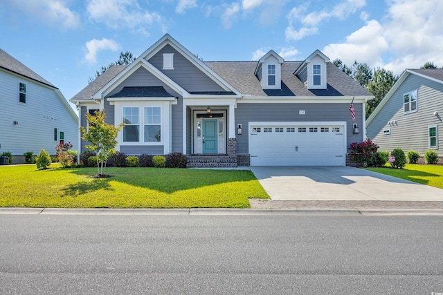 craftsman inspired home with a garage, driveway, roof with shingles, and a front yard