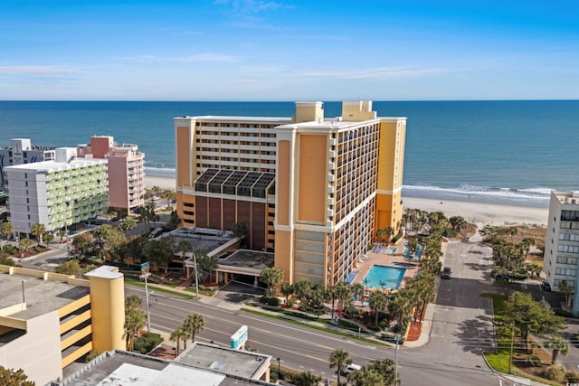 drone / aerial view with a water view and a view of the beach
