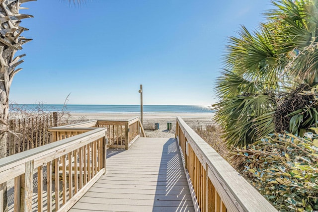 view of property's community with a beach view and a water view