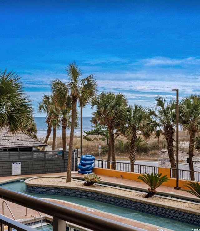 view of swimming pool featuring fence