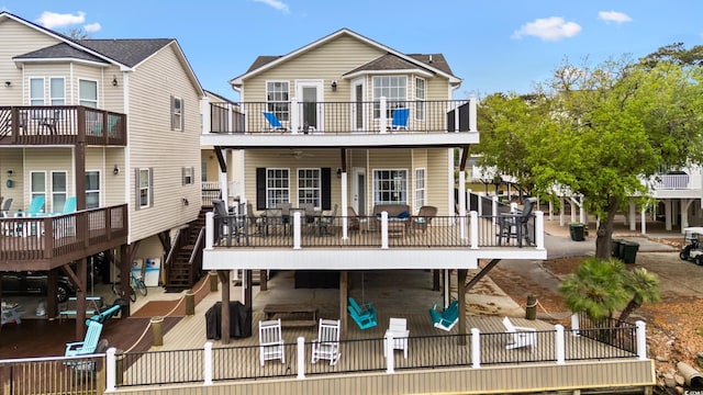 view of front facade featuring a patio, a deck, and stairs