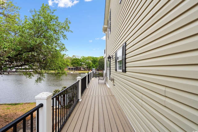 wooden terrace featuring a water view