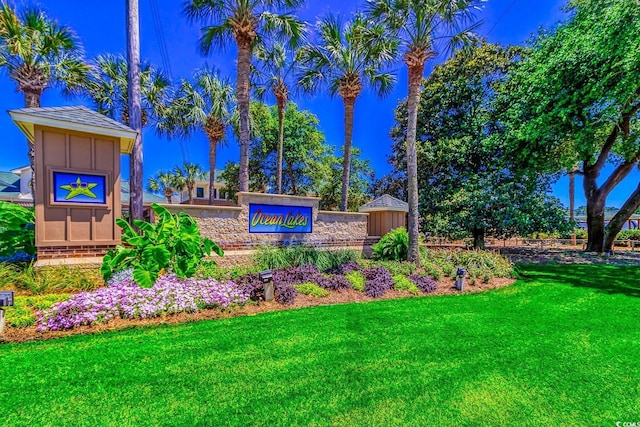 community / neighborhood sign with a lawn