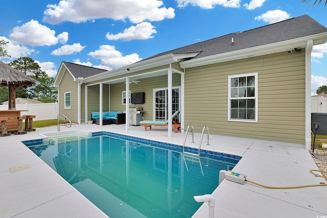 view of pool with a patio, a fenced in pool, outdoor lounge area, outdoor dry bar, and fence