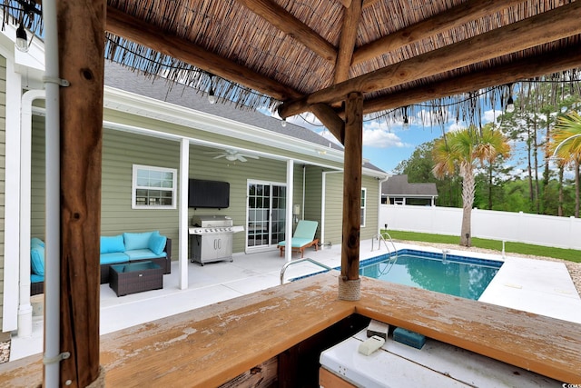 view of pool featuring a fenced in pool, a patio area, grilling area, fence, and a ceiling fan